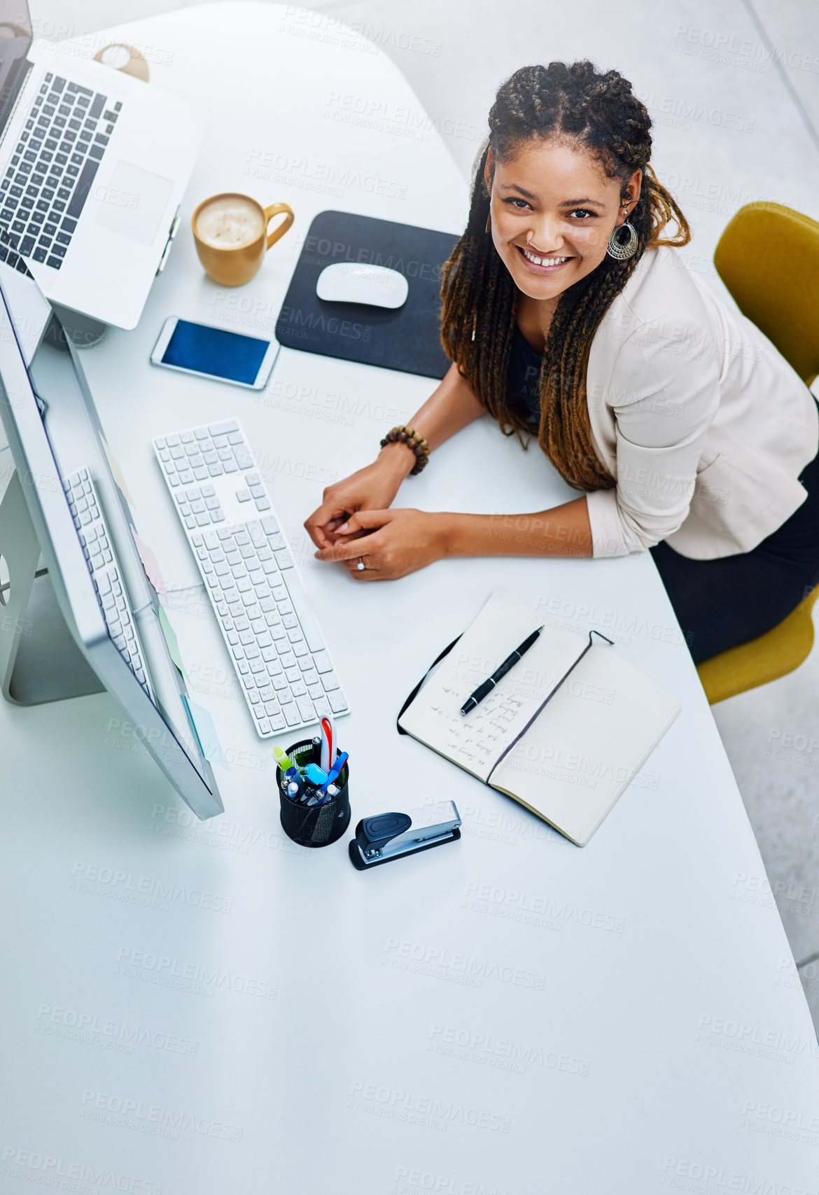 Buy stock photo High angle portrait of an attractive young businesswoman sitting at her desk in the office