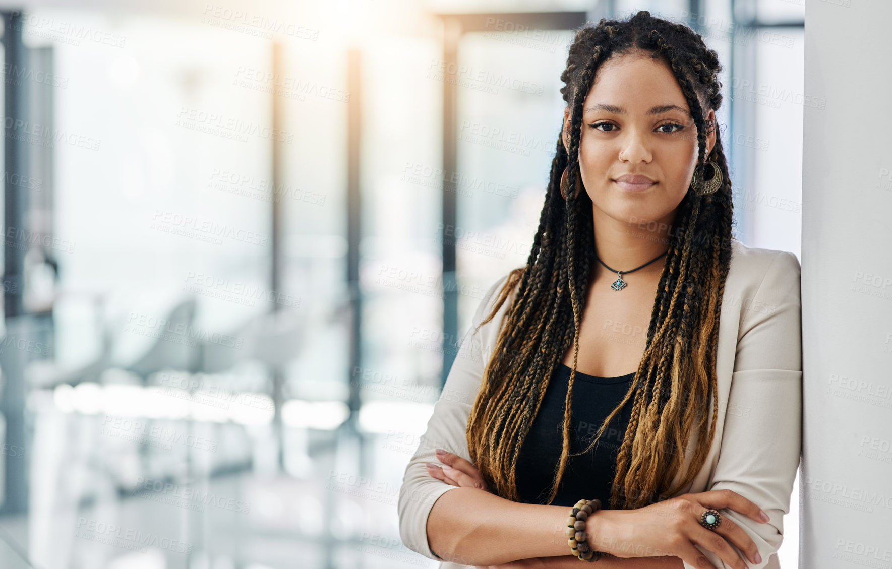 Buy stock photo Cropped portrait of an attractive young female designer standing with her arms crossed in the office