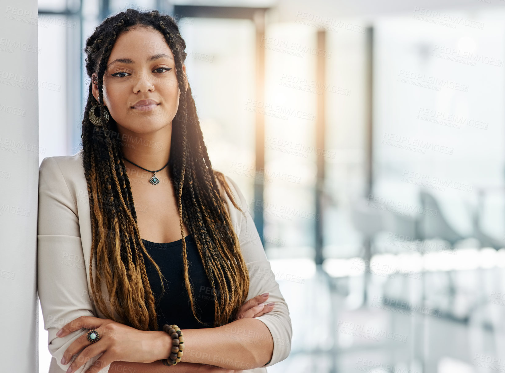 Buy stock photo Cropped portrait of an attractive young female designer standing with her arms crossed in the office