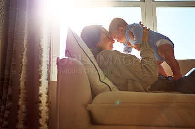 Buy stock photo Happy, mother and baby on sofa relax on weekend for love, bonding and relationship development in home. Care, woman and child together on couch in summer for safety, support or playing in living room