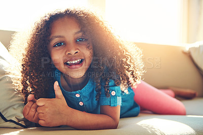 Buy stock photo Portrait of a happy little girl relaxing on the couch at home