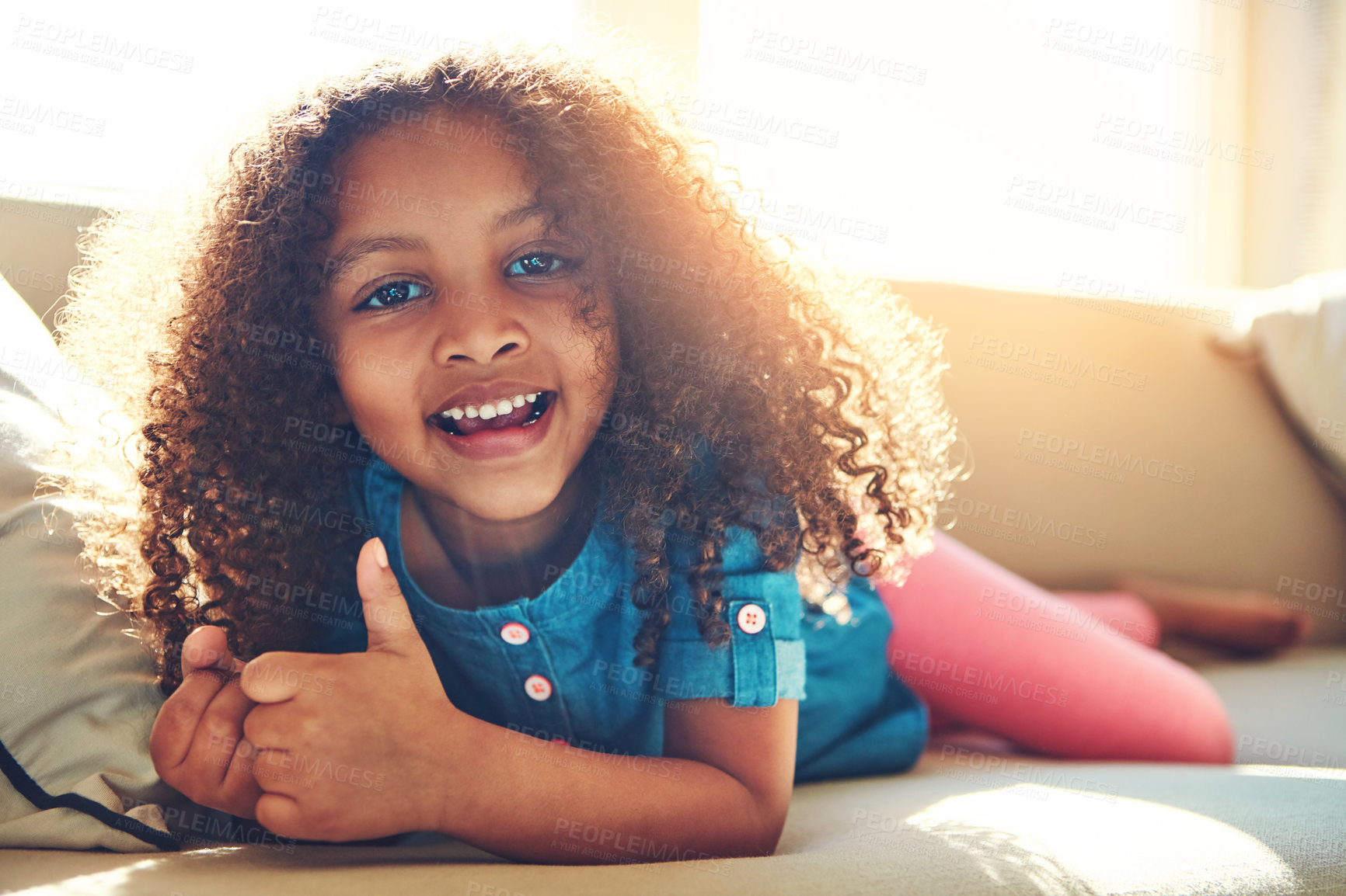 Buy stock photo Portrait of a happy little girl relaxing on the couch at home