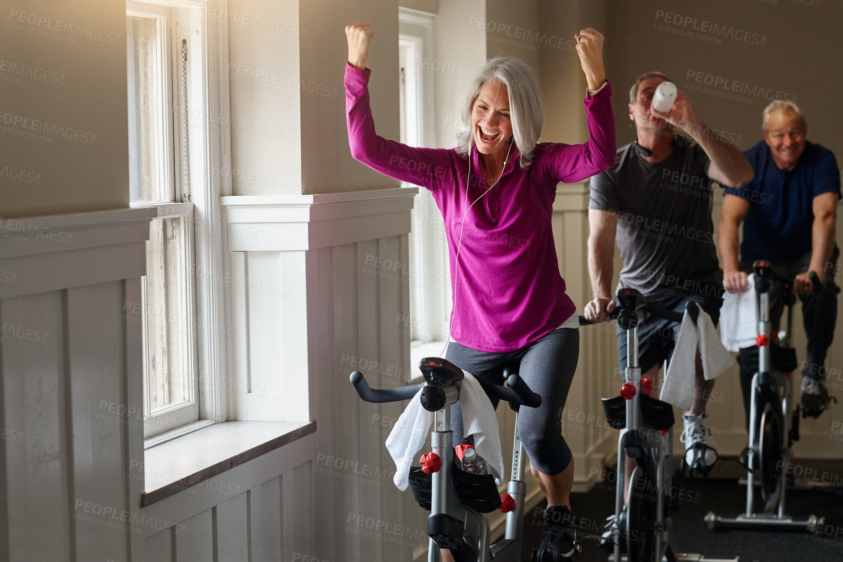 Buy stock photo Class, success or happy woman on cycling bike in workout or cardio training for progress, health or wellness. Gym, winner or excited senior person on bicycle machine for fitness, exercise and goal