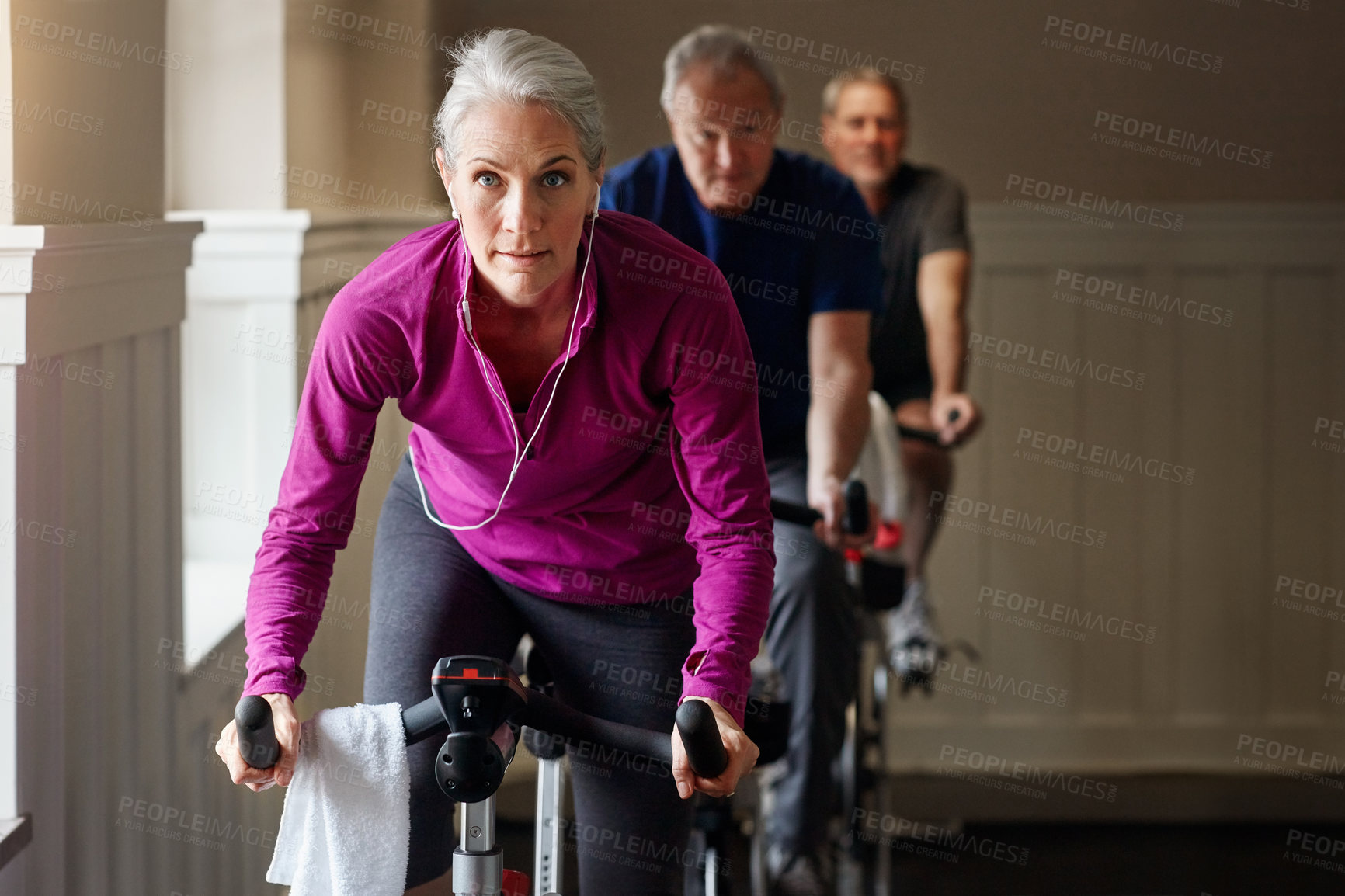 Buy stock photo Shot of a group of people having a spinning class at the gym