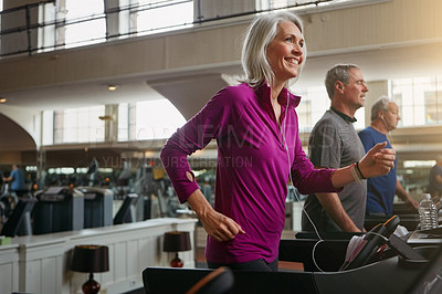 Buy stock photo Shot of a group of mature people exercising on treadmills at the gym