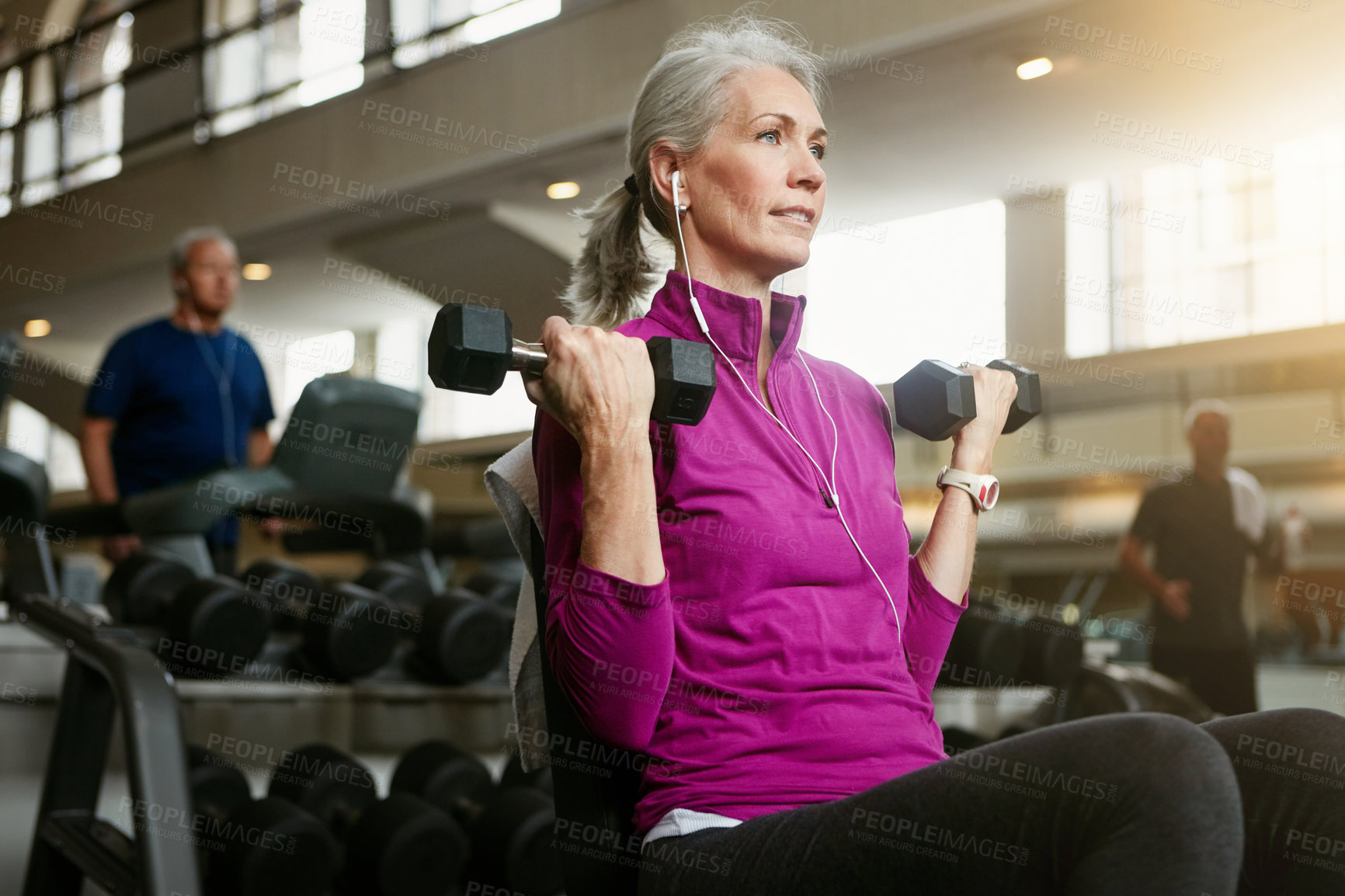 Buy stock photo Active, dumbbell and music with mature woman on bench in gym for physical training or workout. Exercise, fitness and health with confident athlete person in performance club for wellness challenge