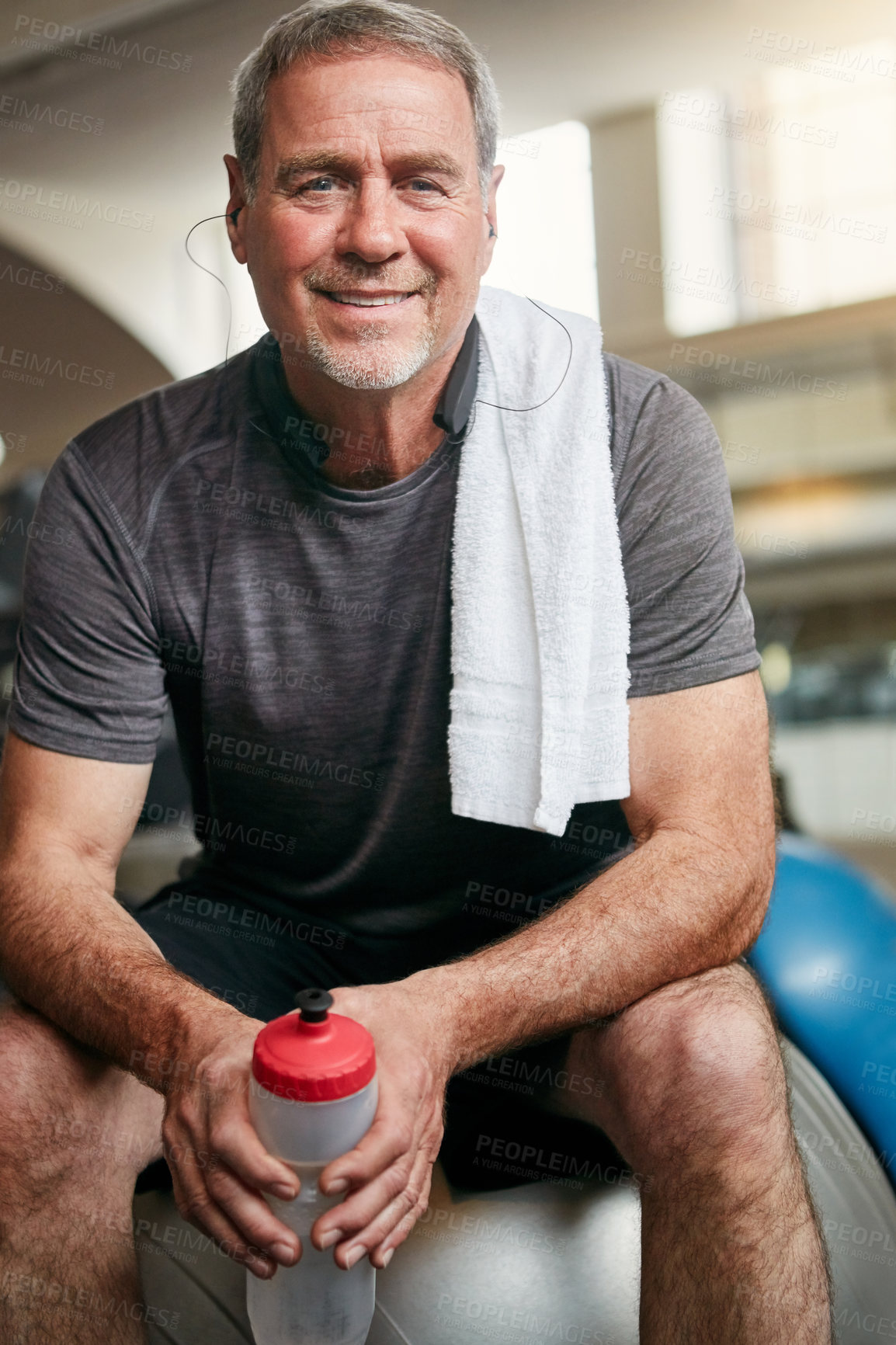 Buy stock photo Relax, gym and portrait of mature man with smile, fitness and happiness with water bottle at workout. Exercise, training and confident athlete on break with pride, health and wellness in sports club.