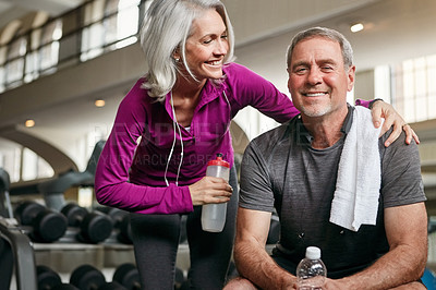 Buy stock photo Shot of a mature couple working out together at the gym