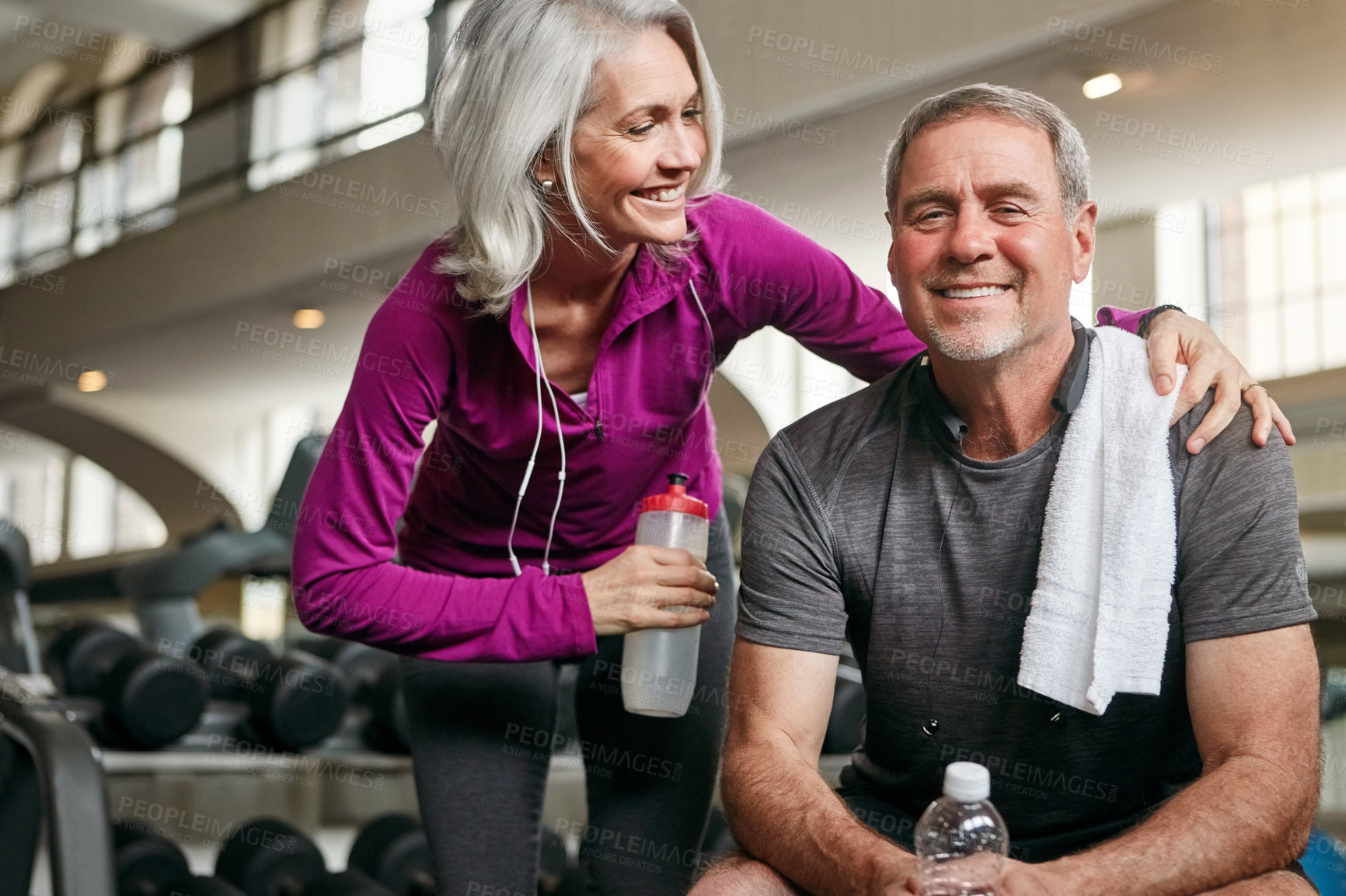 Buy stock photo Shot of a mature couple working out together at the gym