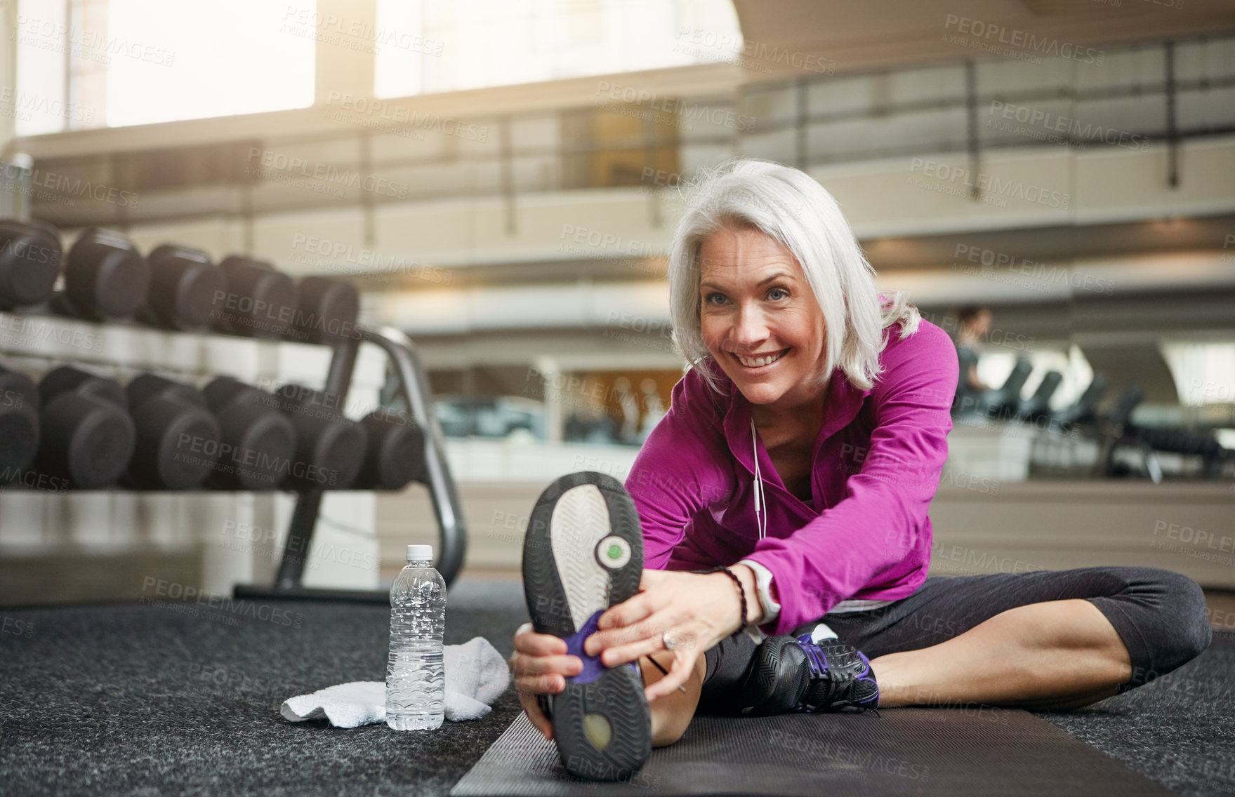 Buy stock photo Feet, fitness or mature woman stretching on gym floor for wellness, training or low impact workout with morning cardio. Sports, warm up or happy person with ground exercise for balance or flexibility