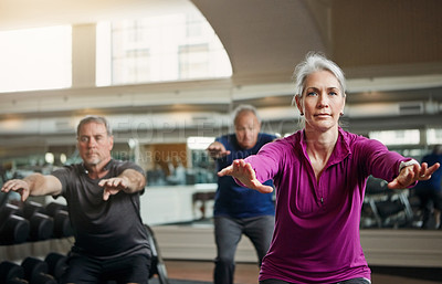 Buy stock photo Shot of a senior group of woman and men working out together at the gym