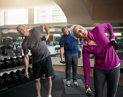 Buy stock photo Senior fitness club, stretching and people with dumbbells at gym for training, wellness or exercise. Class, workout and elderly men with personal trainer for weightlifting, support or bodybuilding