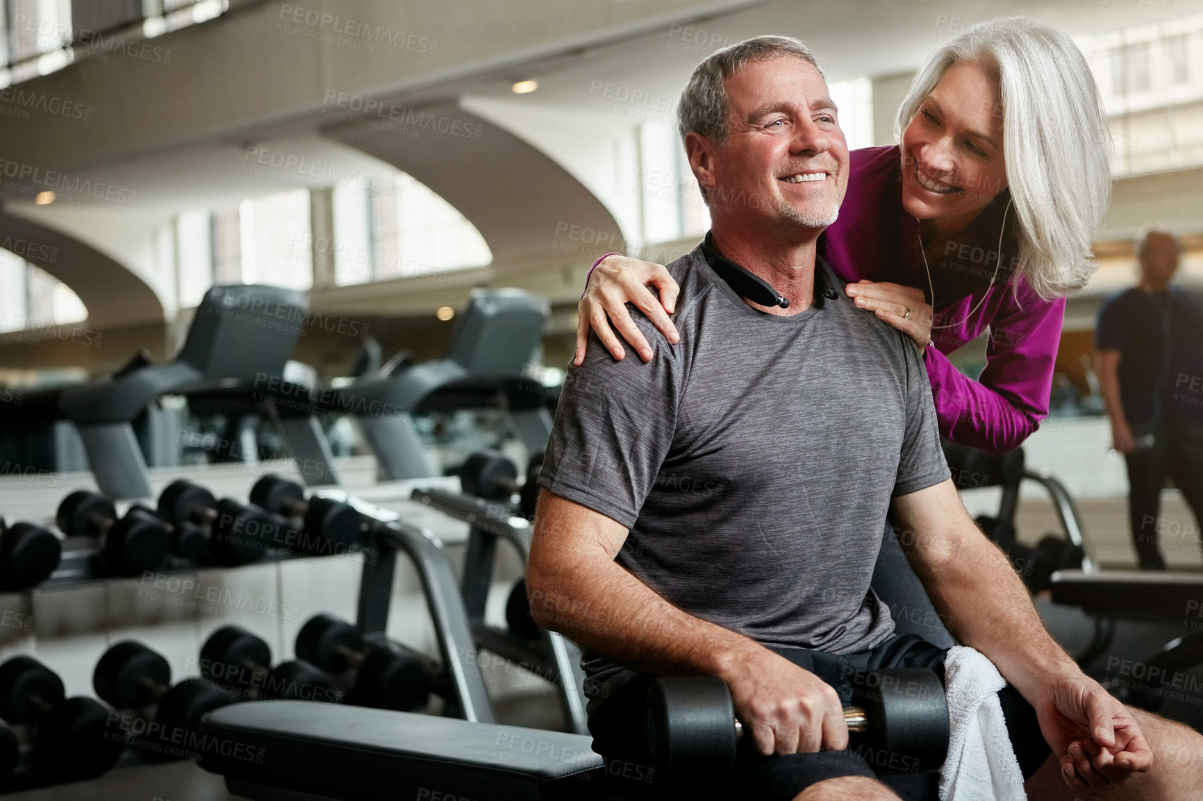 Buy stock photo Mature couple, dumbbell and workout for support, care or happy with weightlifting for wellness at gym. People, man and woman with smile for motivation, training or exercise for health at fitness club