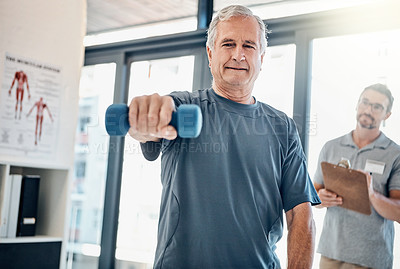 Buy stock photo Shot of a mature man lifting a dumbbell while his physiotherapist supervises in the rehabilitation center
