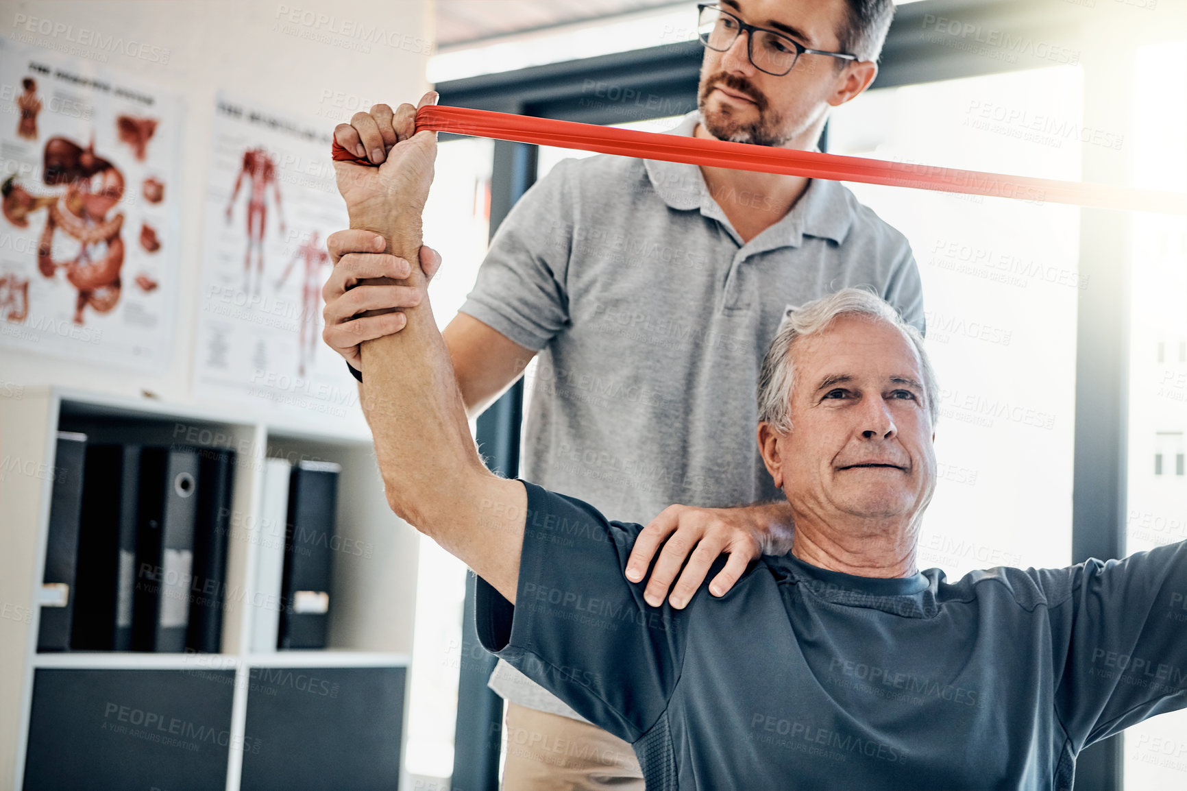 Buy stock photo Help, physiotherapist and old man with resistance band, stretching and senior care rehabilitation. Physio, caregiver and elderly patient for mobility training, exercise and healthcare in retirement.