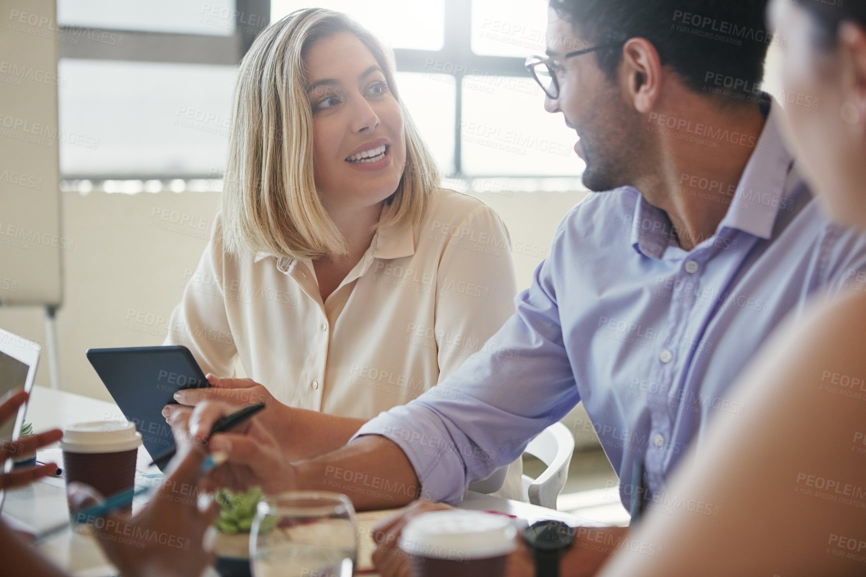 Buy stock photo Shot of a team of business colleagues discussing a project around a table in their office