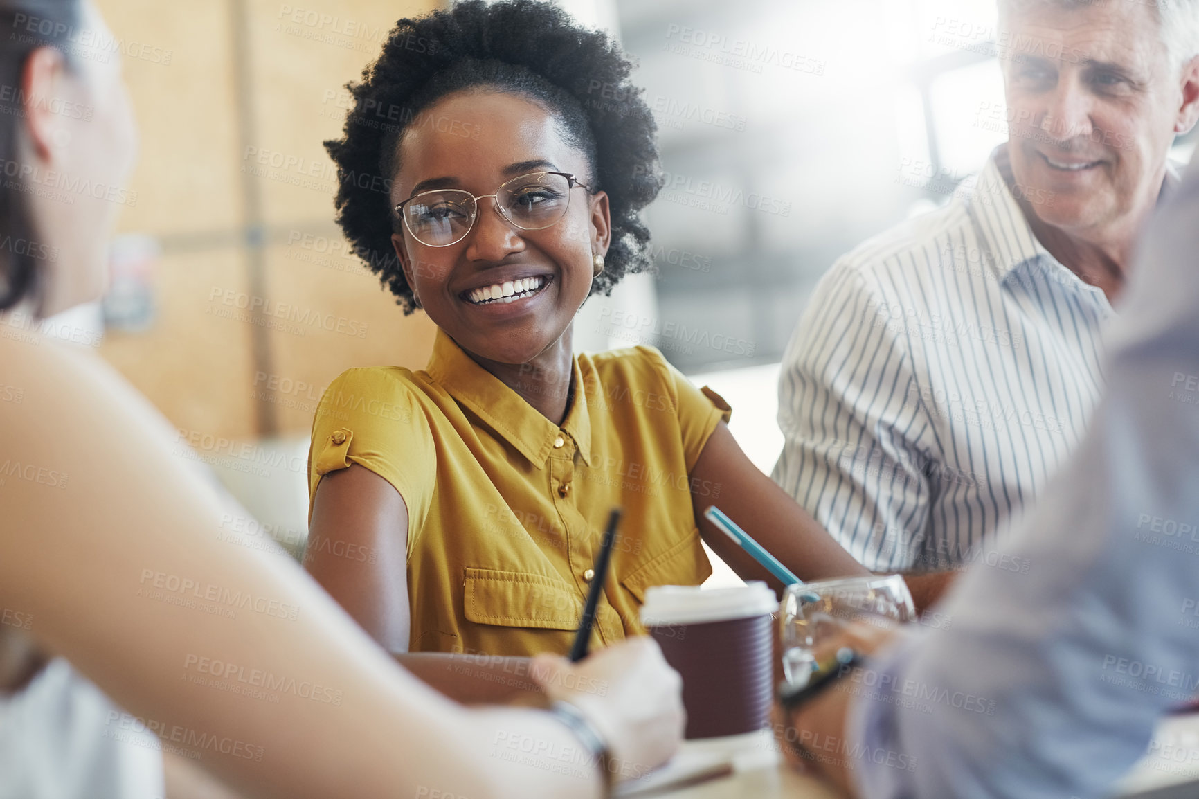 Buy stock photo Shot of a team of happy business colleagues discussing a project around a table in their office