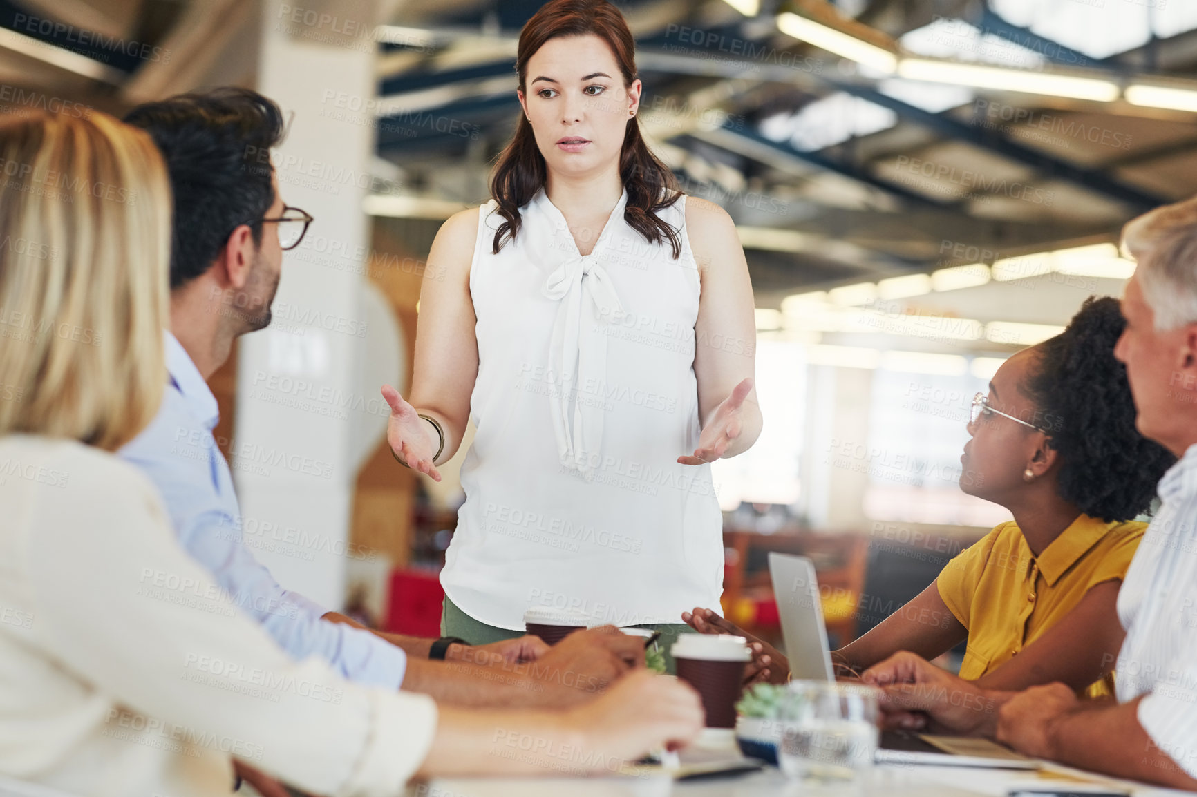 Buy stock photo Shot of a confident businesswoman presenting an idea to her colleagues in the office