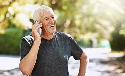 Buy stock photo Shot of a senior man talking on a cellphone while out for a run
