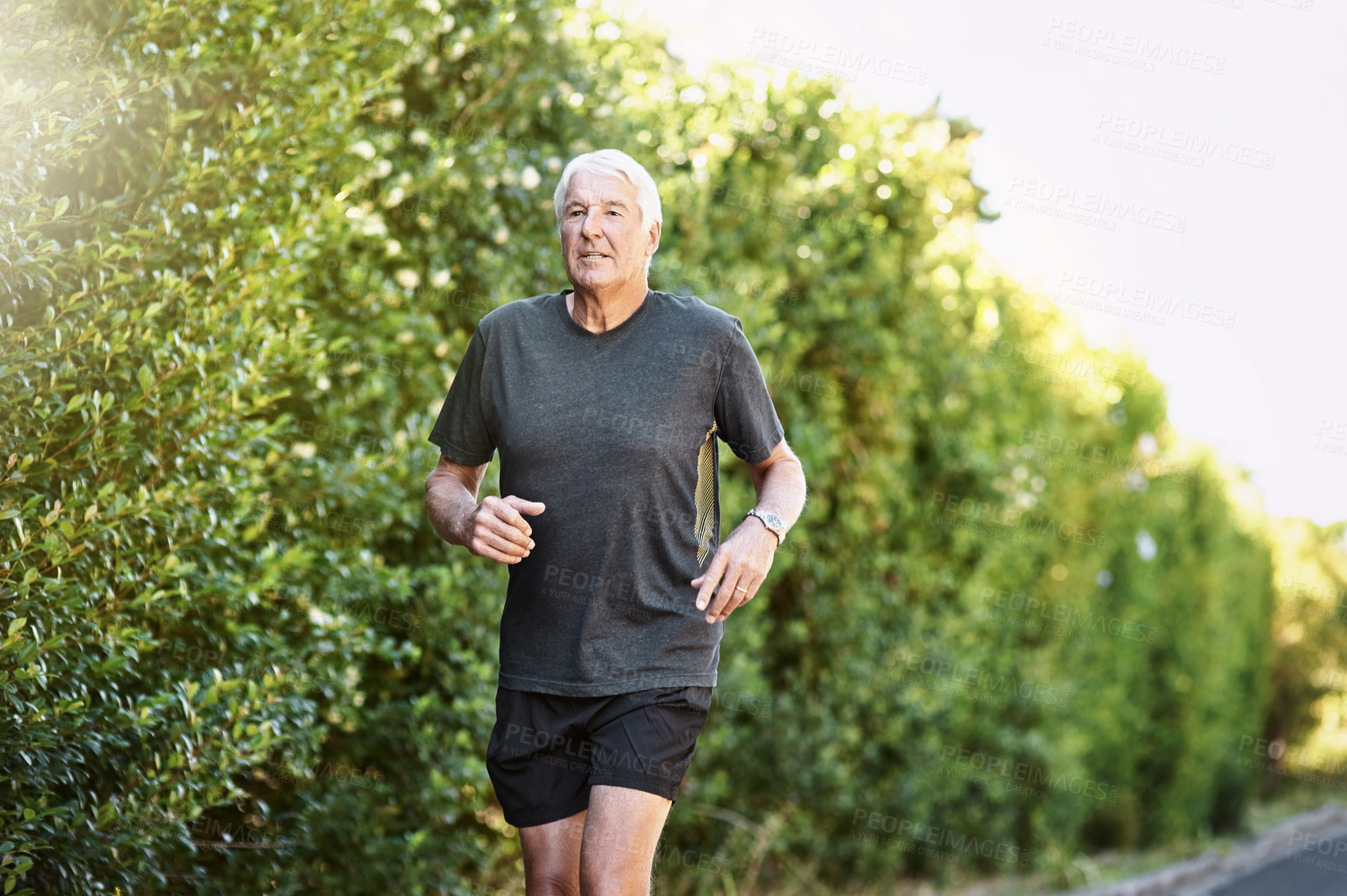 Buy stock photo Shot of a senior man out for a run