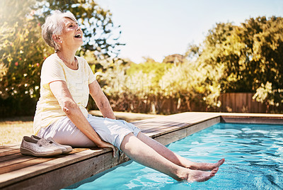 Buy stock photo Elderly woman with her feet in the water of the pool while on a vacation, adventure or outdoor trip in summer. Happy, smile and senior lady in retirement relaxing by swimming pool at a holiday resort