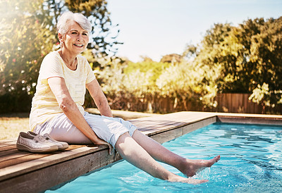 Buy stock photo Senior woman with her feet in the pool while on a vacation, adventure or outdoor trip in summer. Happy, smile and elderly lady in retirement relaxing by swimming pool at a holiday resort in Australia