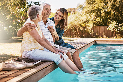 Buy stock photo Relax, senior couple and woman with feet in swimming pool enjoying summer holiday, vacation and weekend. Family, love and daughter with elderly parents for bonding, quality time and laughing together