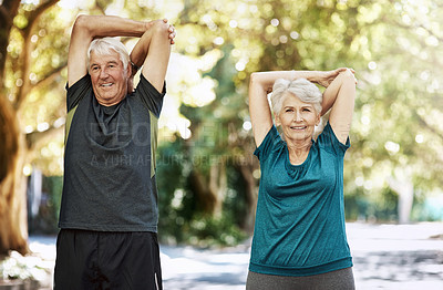 Buy stock photo Shot of a senior couple warming up before a run outside