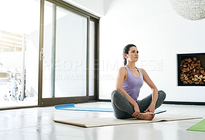Buy stock photo Shot of an attractive young woman practising yoga at home