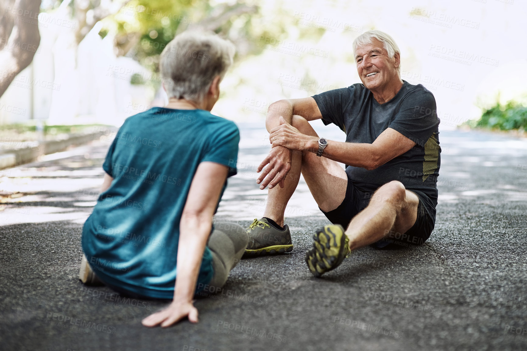 Buy stock photo Shot of a senior couple taking a break while out for a run together