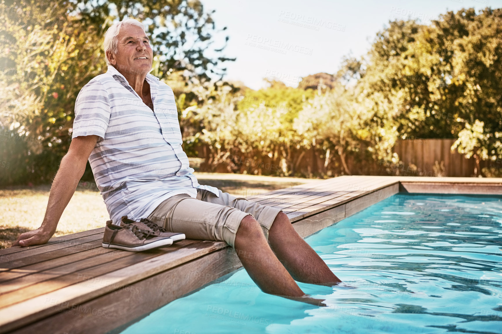 Buy stock photo Relax, retirement and thinking with old man by swimming pool and for summer, peace and happy. Smile, calm and vacation with senior citizen with feet in water on break for happiness, holiday and fun