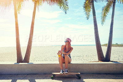 Buy stock photo Shot of a young woman hanging out on the boardwalk with her skateboard