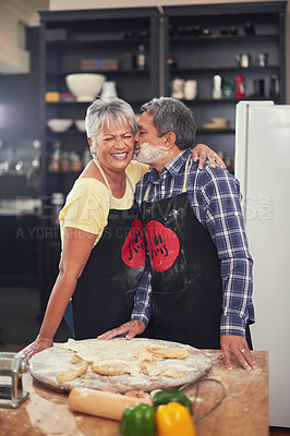 Buy stock photo Cooking, kiss and senior couple in kitchen at home with dough, flour and ingredients for meal. Happy, food and elderly man and woman preparing dinner, lunch or supper together at house in Mexico.