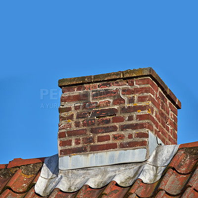 Buy stock photo Closeup of red brick chimney on an asbestos roof against a blue sky. Architecture design on house building for smoke extraction from fireplace or furnace. Combustion gases for home insulation