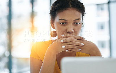 Buy stock photo Shot of a young designer working on a laptop in an office