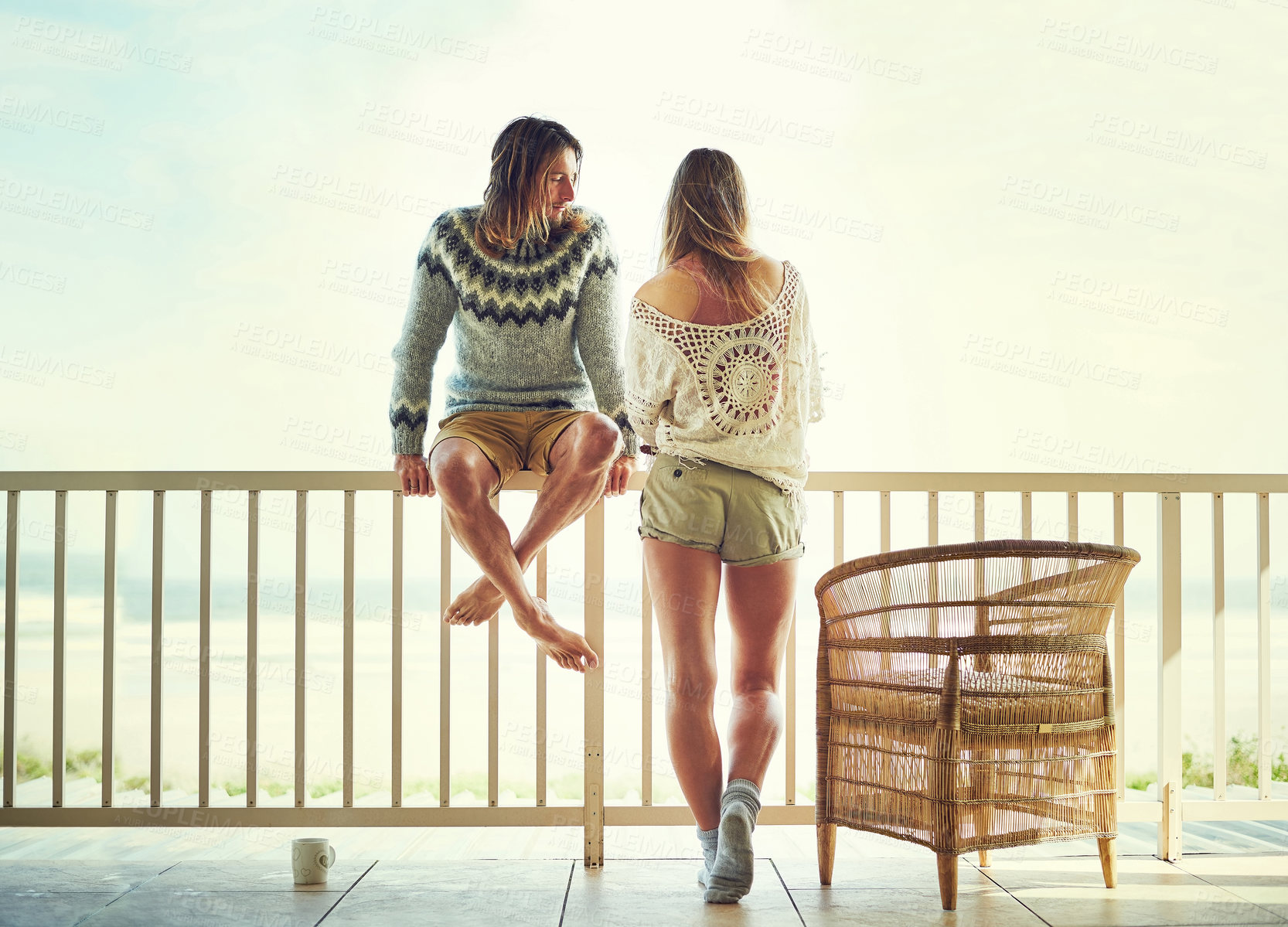 Buy stock photo Shot of a young couple relaxing on their balcony