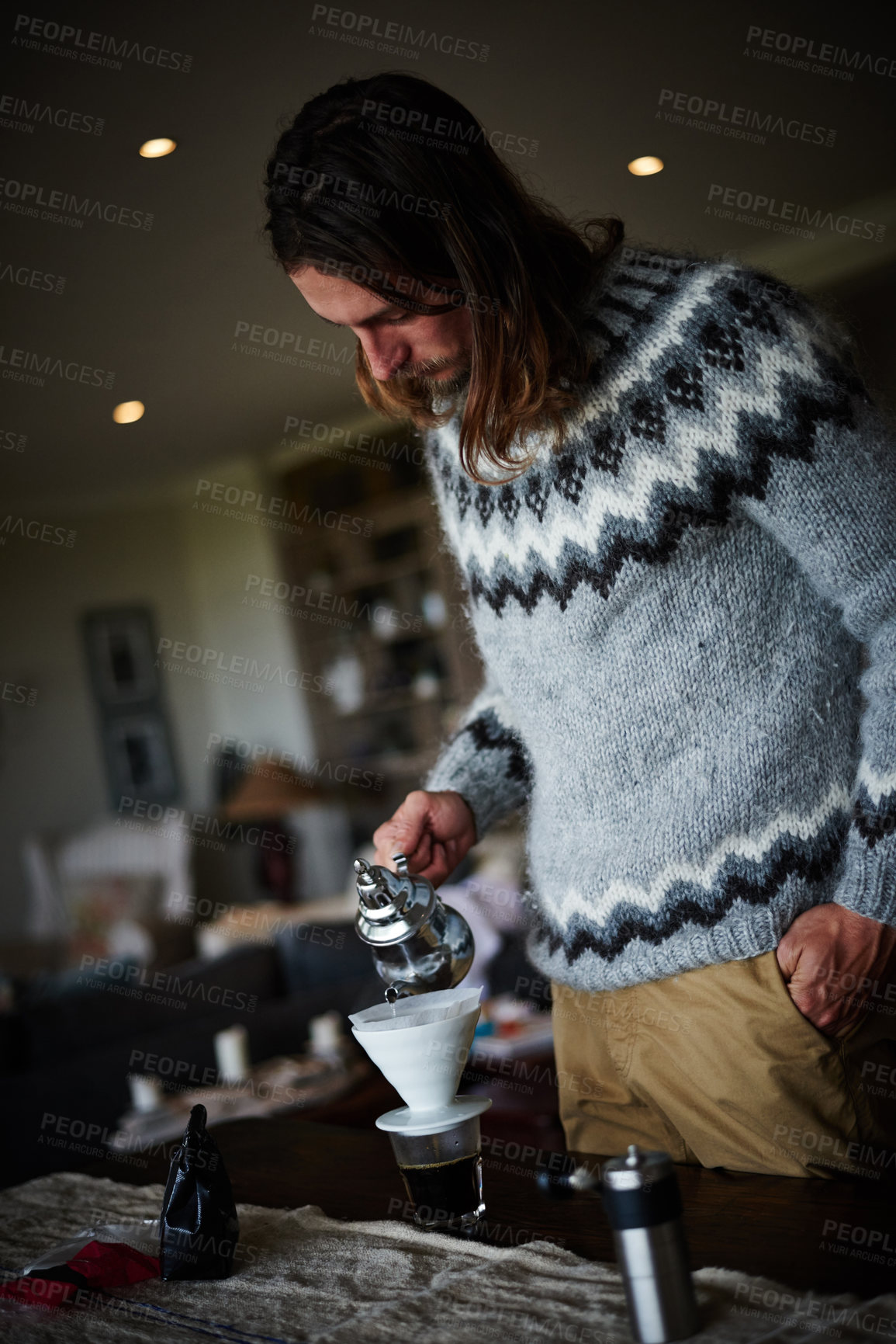 Buy stock photo Shot of a young man preparing coffee in his kitchen