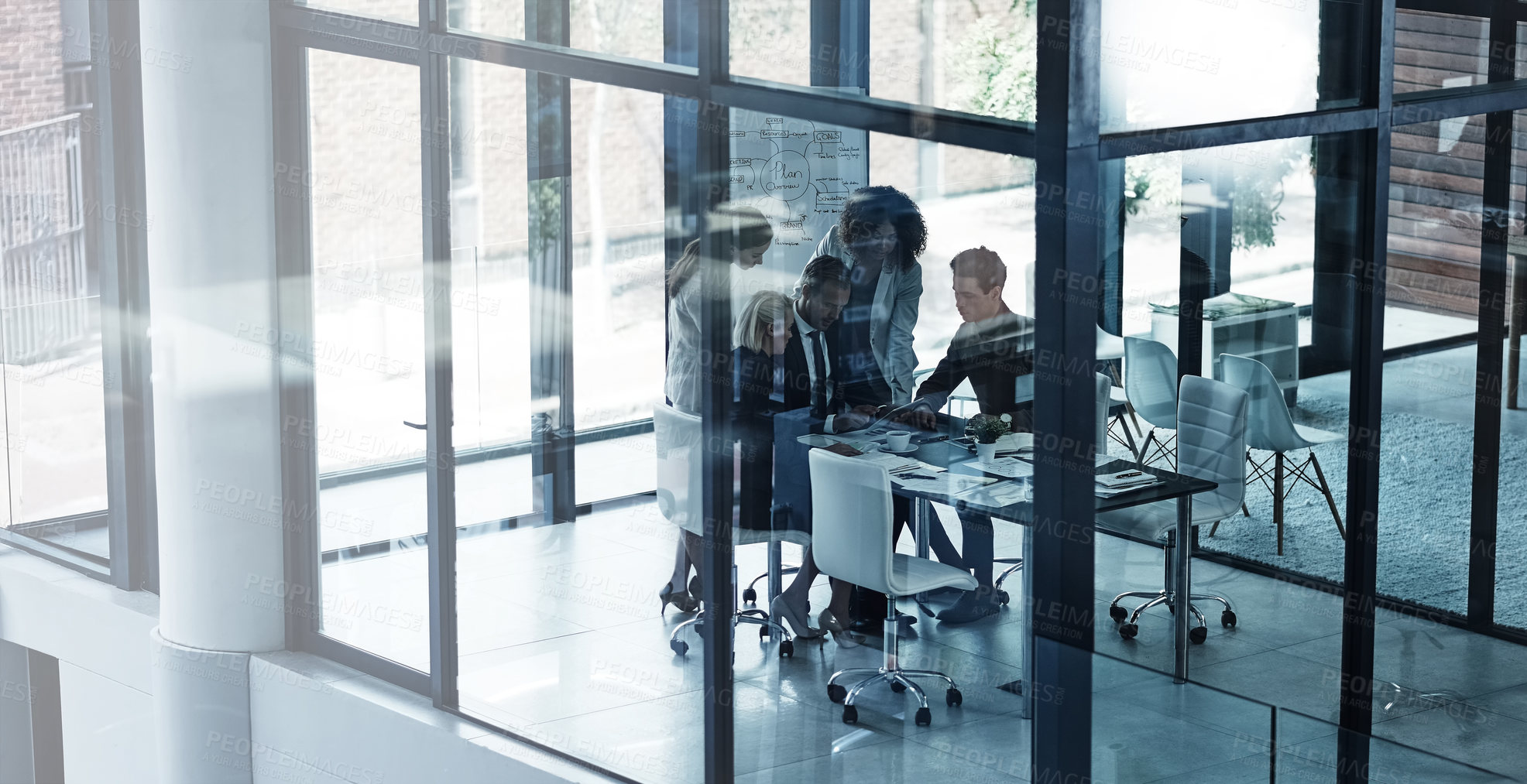 Buy stock photo Shot of a group of corporate businesspeople looking at a tablet together during a meeting in the boardroom