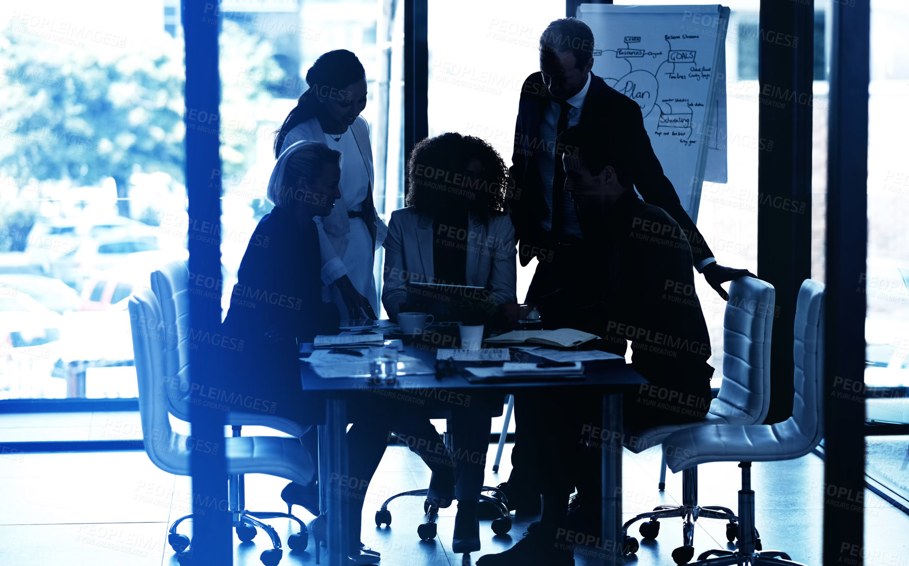 Buy stock photo Shot of a group of corporate businesspeople looking at a tablet together during a meeting in the boardroom