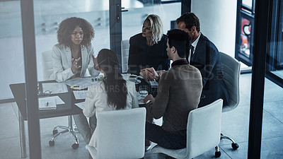 Buy stock photo Shot of a group of corporate businesspeople sitting in the boardroom during a meeting