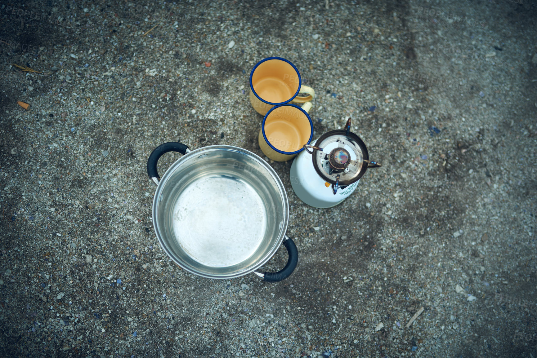 Buy stock photo Gas stove, cup and outdoor on ground for camping, cleaning and boil for safety from bacteria. Pot, container and above stove for water, cooking or washing for hygiene in nature for adventure in India