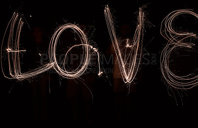 Buy stock photo Shot of the word love being drawn with a sparkler through use of light painting outside at night