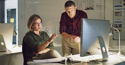 Buy stock photo Cropped shot of two businesspeople working together on a computer in their office