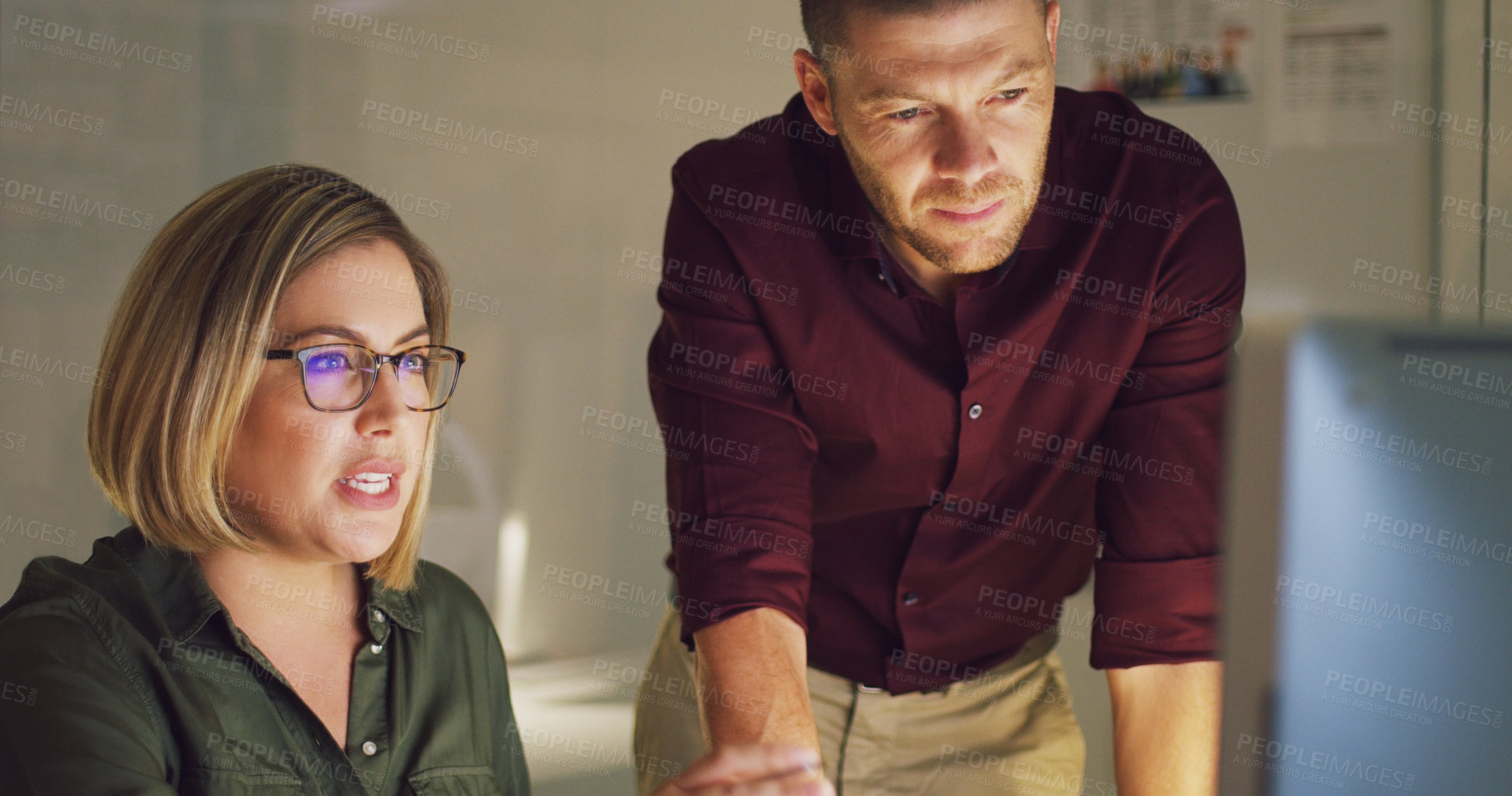 Buy stock photo Cropped shot of two businesspeople working together on a computer in their office