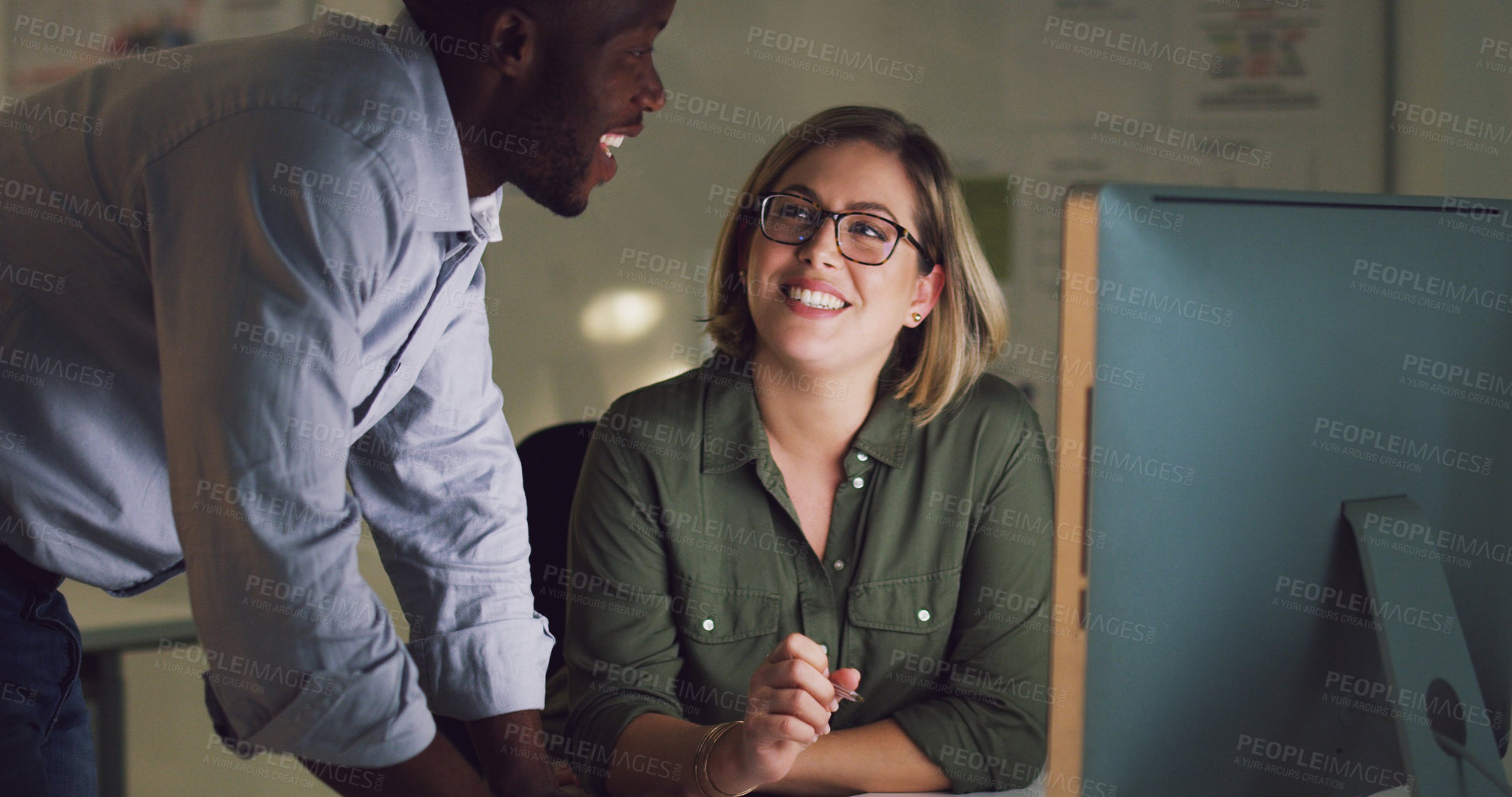 Buy stock photo Cropped shot of two businesspeople working together on a computer in their office