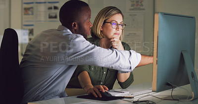 Buy stock photo Cropped shot of two businesspeople working together on a computer in their office