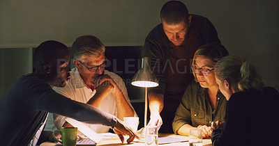 Buy stock photo Cropped shot of a group of businesspeople working together around a table in their office