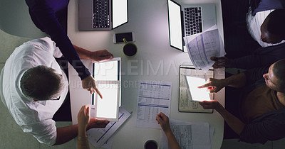 Buy stock photo High angle shot of a group of businesspeople working together around a table in their office