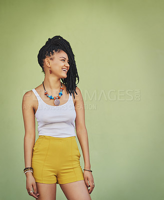 Buy stock photo Shot of an attractive and trendy young woman posing against a green background