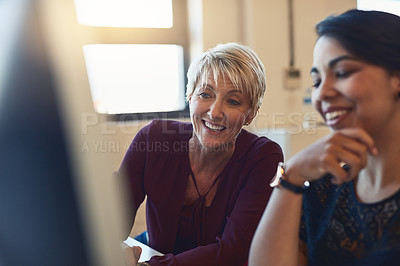 Buy stock photo Shot of two designers working together on a computer in an office